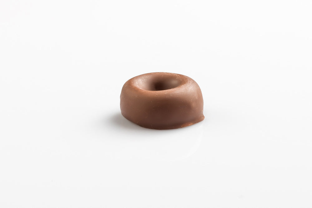 Single chewy aniseed ring coated in smooth milk couverture chocolate from Share Chocolates