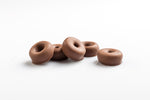 Group of 5 chewy aniseed rings coated in smooth milk couverture chocolate