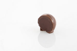 Single Butterscotch Cream Truffle Cut in half to reveal a rich butterscotch truffle filling