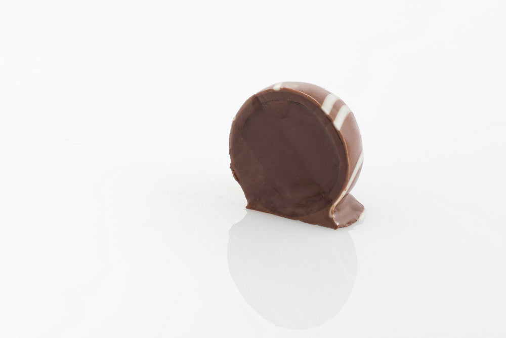 Single Chocolate Fudge Truffle Cut in half to reveal smooth milk couverture chocolate ganache filling