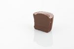 Single Classic Milk Truffle Cut in half to reveal smooth milk couverture chocolate