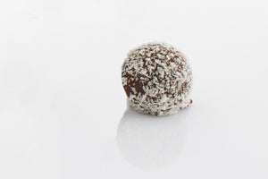 Milk couverture chocolate ganache filling enrobed in milk chocolate and rolled in coconut flakes