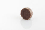 Single Coconut Rough Truffle Cut in half to reveal a milk couverture chocolate gancahe filling