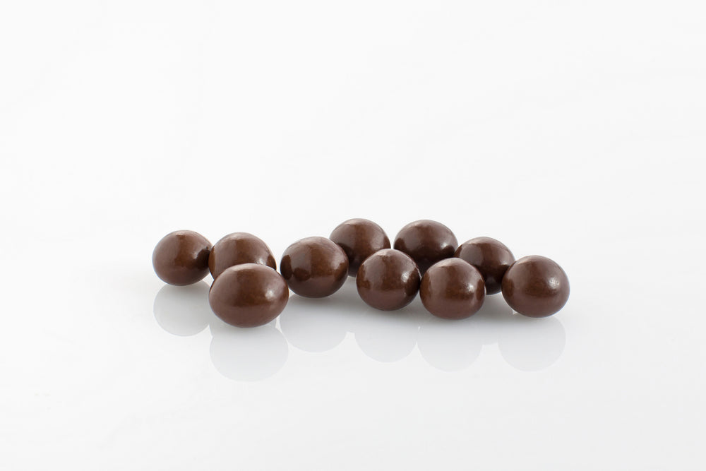 Group of dark chocolate coated crunchy coffee beans