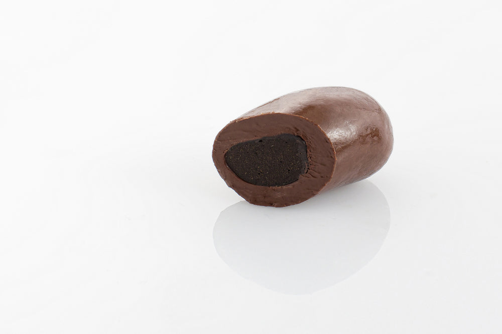 Single Jumbo Sized Dark Liquorice Bullet cut in half