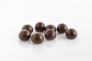 Group of chewy raspberries encased in smooth dark couverture chocolate from Share Chocolates