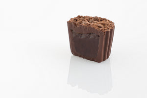 Single Jaffa Truffle Cut in half to reveal a smooth dark couverture chocolate truffle centre