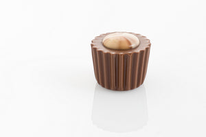 Caramel Cream Truffle encased in couverture milk chocolate and decorated with a swirled milk and white chocolate button