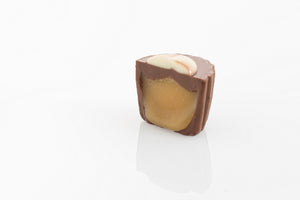 Single Caramel Cream Truffle Cut in half to reveal a thick caramel cream filling