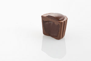 Single Milk Ganache Truffle Cut in half to reveal a mellow and creamy milk couverture chocolate ganache centre