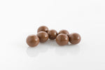 Group of Malt Balls coated in couverture  milk chocolate from Share Chocolates