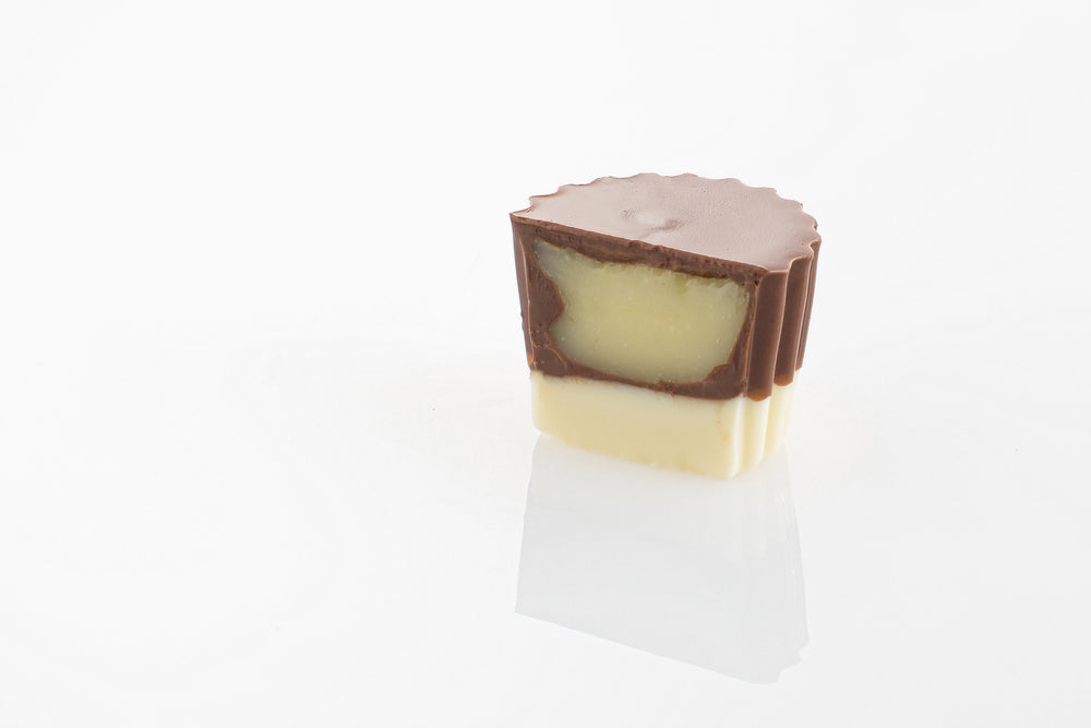 Single Milk On White Truffle Cut in half to reveal a smooth white chocolate ganache filling