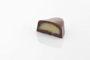 Single Peppermint Cream Truffle Cut in half to reveal a smooth peppermint cream centre