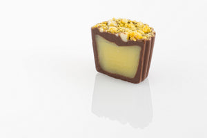 Single Pineapple Truffle Cut in half to reveal a tropical pineapple cream filling