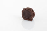 Single Rum Ball cut in half to reveal a creamy dark couverture chocolate and rum infused truffle filling