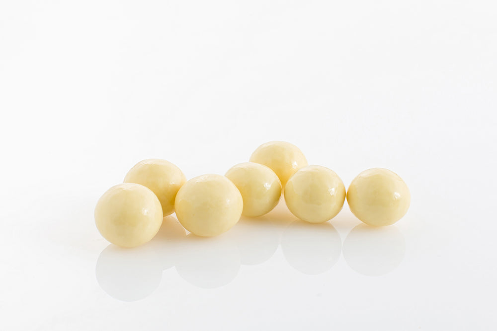 Group of Malt Balls coated in couverture white chocolate from Share Chocolates